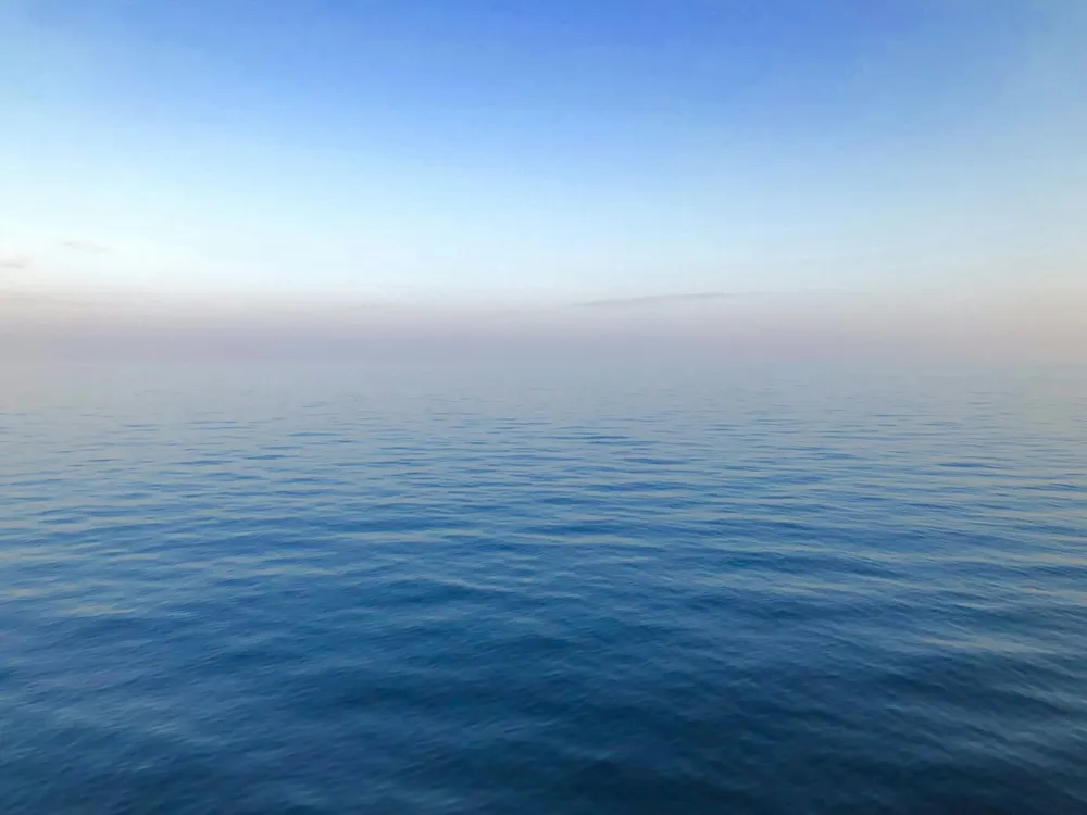 Mar en calma bajo un cielo pálido
